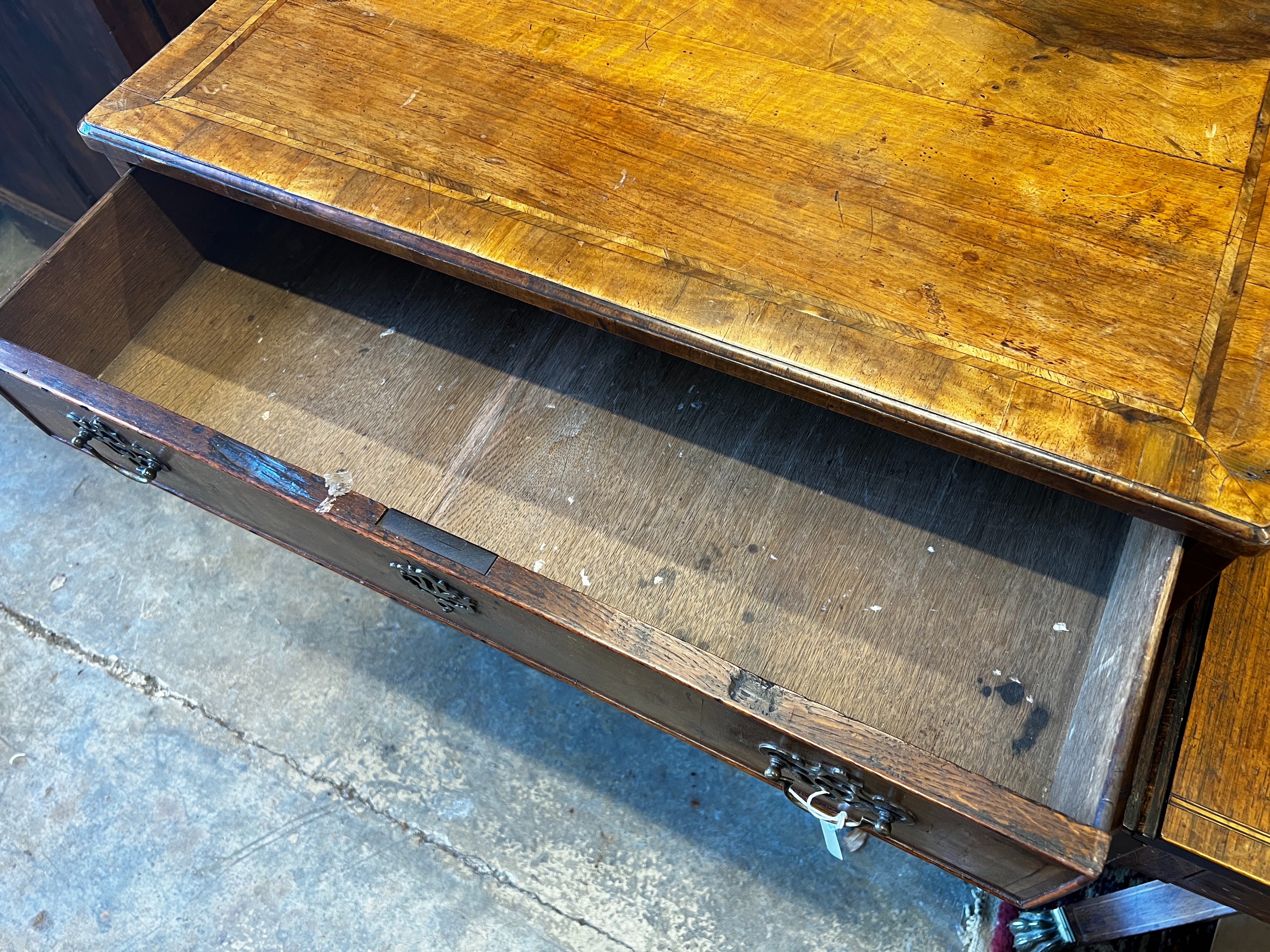 An 18th century feather banded walnut kneehole desk, length 78cm, depth 49cm, height 81cm